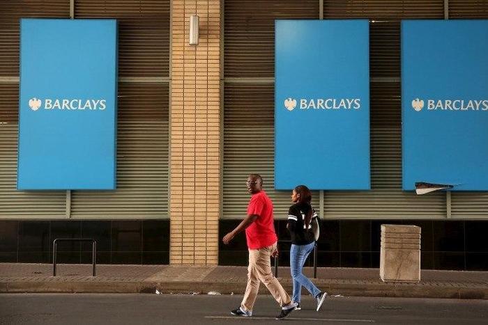 A couple walks past a Barclays logo in Johannesburg December 16, 2015. REUTERS/Siphiwe Sibeko