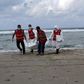 Libyan Red Crescent workers carry the body of one of the migrants who died after a boat sank off the coastal town of Khoms area east of Tripoli, Libya October 25, 2015. REUTERS/Ismail Zitouny