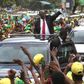 Tanzania"s President elect John Pombe Magufuli (C) salutes members of the ruling Chama Cha Mapinduzi Party (CCM) as he arrives at the party"s sub-head office on Lumumba road in Dar es Salaam, October 30, 2015.