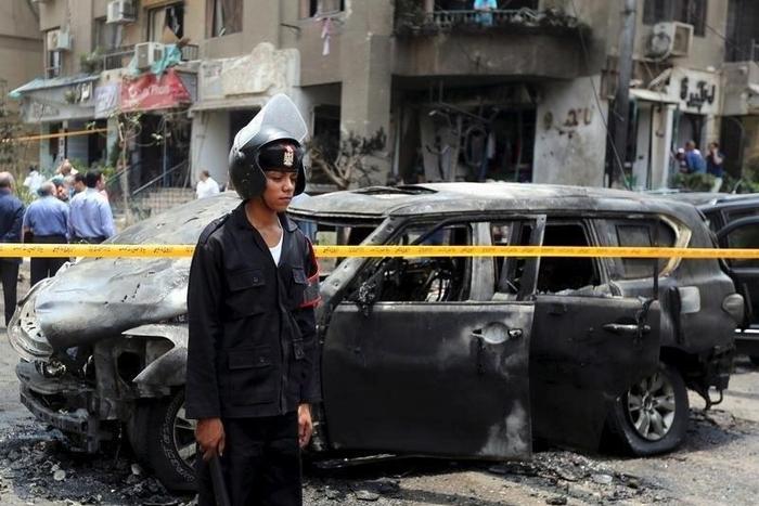 Policemen investigate the site of a car bomb attack on the convoy of Egyptian public prosecutor Hisham Barakat near his house at Heliopolis district in Cairo, Egypt, June 29, 2015. REUTERS/Mohamed Abd El Ghany