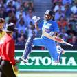 India's Virat Kohli celebrates his century with Australia's Kane Richardson (L) watching during their One Day cricket match at the Melbourne Cricket Ground, January 17, 2016. REUTERS/Hamish Blair