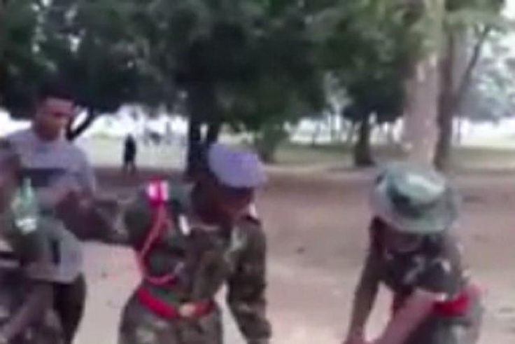 Cadet soldiers torturing a civilian