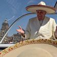 Pope Francis gestures while wearing a Mariachi hat given to him by someone in the crowd on Zocalo Square in Mexico City, February 13, 2016.