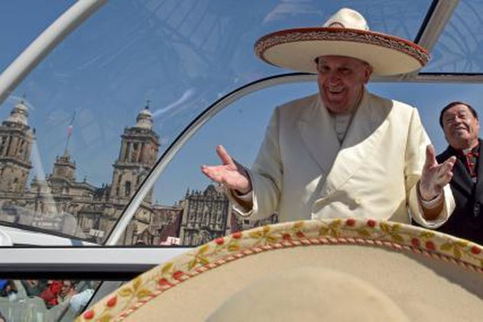 Pope Francis gestures while wearing a Mariachi hat given to him by someone in the crowd on Zocalo Square in Mexico City, February 13, 2016.