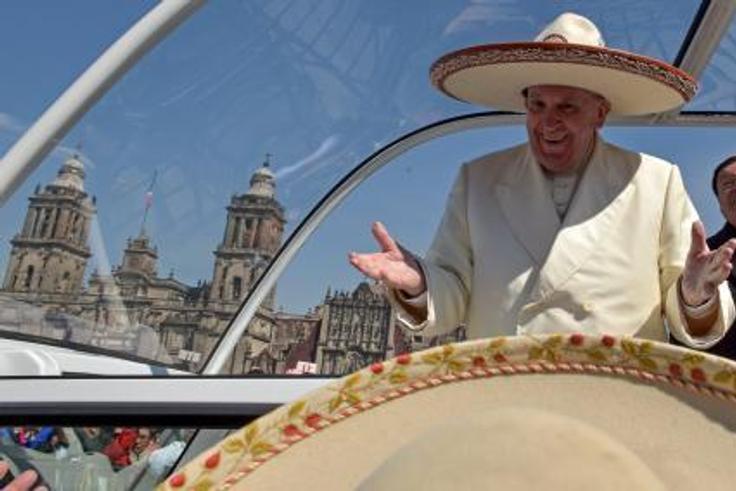 Pope Francis gestures while wearing a Mariachi hat given to him by someone in the crowd on Zocalo Square in Mexico City, February 13, 2016.
