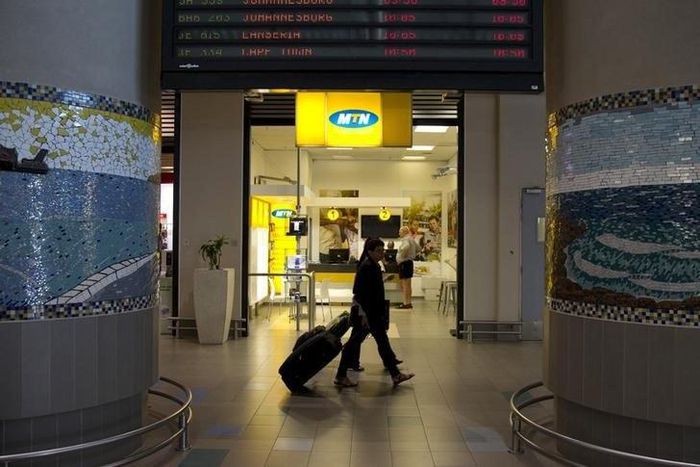 Travellers walk past an MTN telecom shop at King Shaka International Airport in Durban, South Africa, November 16, 2015. REUTERS/Rogan Ward