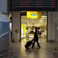 Travellers walk past an MTN telecom shop at King Shaka International Airport in Durban, South Africa, November 16, 2015. REUTERS/Rogan Ward