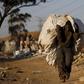 An unemployed man carries a bag full of recyclable waste material which he sells for a living, in Daveland near Soweto, South Africa August 4, 2015. REUTERS/Siphiwe Sibeko