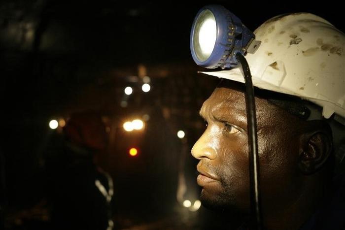 A mine worker looks on underground in Modderfontein east mine, outside Johannesburg, February 3, 2009. REUTERS/Siphiwe Sibeko