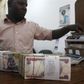 A money dealer counts the Nigerian naira on a machine in his office in the commercial capital of Lagos,   in a file photo. REUTERS/Akintunde Akinleye