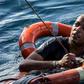 A migrant is rescued with buoys and a rope, after he dived in the Mediterranean off Malta's coast from the Dutch-flagged Sea-Watch 3 rescue vessel