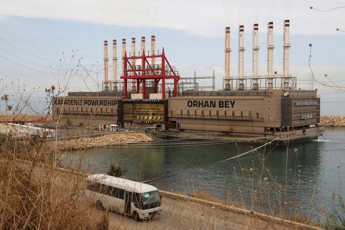 A bus drives past the Karadeniz Powership Orhan Bey, an electricity-generating ship from Turkey, docked at the port of Jiyeh, south of Beirut, Lebanon October 26, 2015. REUTERS/Aziz Taher