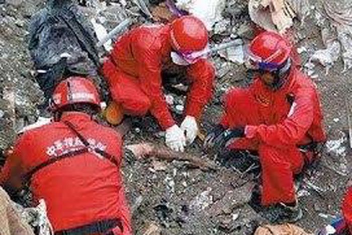 Rescue workers discover dead couple with arms wrapped around each other under rubble