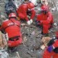 Rescue workers discover dead couple with arms wrapped around each other under rubble