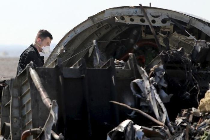 A military investigator from Russia stands near the debris of a Russian airliner at its crash site at the Hassana area in Arish city, north Egypt, November 1, 2015. REUTERS/Mohamed Abd El Ghany
