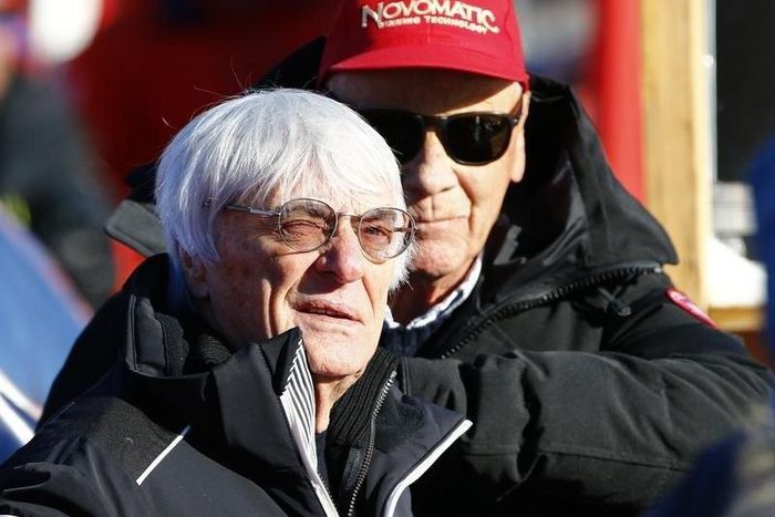 Formula One Chief Executive Bernie Ecclestone (L) reacts next to Former Formula One champion Niki Lauda as they watch the men's Alpine Skiing World Cup Super G race on the Streif course in Kitzbuehel, Austria, January 22, 2016.  REUTERS/Leonhard Foeger