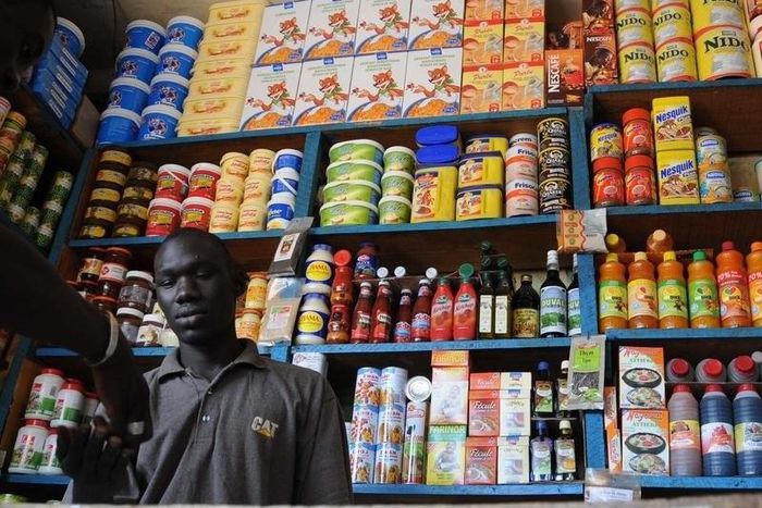 A shopkeeper receives payment in a roadside kiosk in Senegal's capital Dakar, file. REUTERS/Ricci Shryock/Files