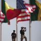 American security officers scan the airport from a rooftop below Senegalese and American flags before the departure of U.S. President Barack Obama in Dakar, Senegal, June 28, 2013. REUTERS/Joe Penney
