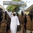Incumbent president Alpha Conde, leader of Rassemblement du Peuple de Guinea (RPG), wavess as he leaves the polling station during a presidential election in Conakry, Guinea October 11, 2015.