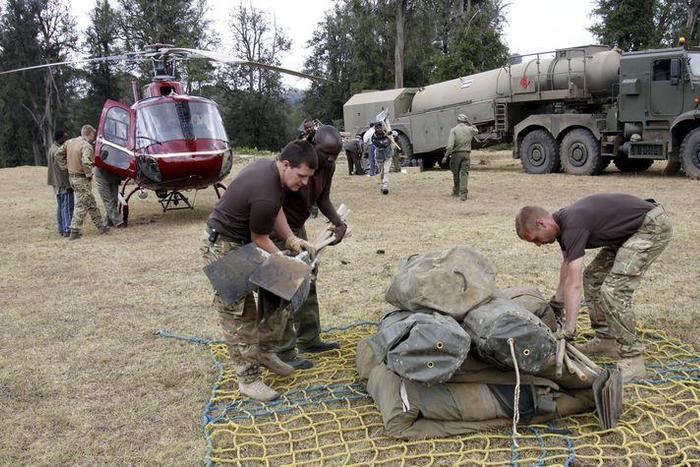 Members of the British Army pack their belongings after an operation to extinguish fire on the Chogoria side of the slopes of Mount Kenya in central Kenya, in this March 20, 2012 file photo. Kenya and Britain signed a deal on December 9, 2015 to allow ...