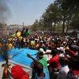 Protesters chant slogans as they burn portable toilets during a protest over planned increases in tuition fees outside the Union building in Pretoria, October 23, 2015. REUTERS/Siphiwe Sibeko