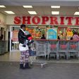 A shopper is seen outside a Shoprite store in Johannesburg July 7, 2015. REUTERS/Siphiwe Sibeko