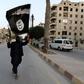 A member loyal to the Islamic State in Iraq and the Levant (ISIL) waves an ISIL flag in Raqqa June 29, 2014. REUTERS/Stringer