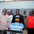 Tanzania's presidential candidate of the ruling Chama Cha Mapinduzi (CCM) party John Pombe Magufuli displays his ballot paper before casting his vote during the presidential and parliamentary election at his hometown Chato district, in Geita region, Oc...