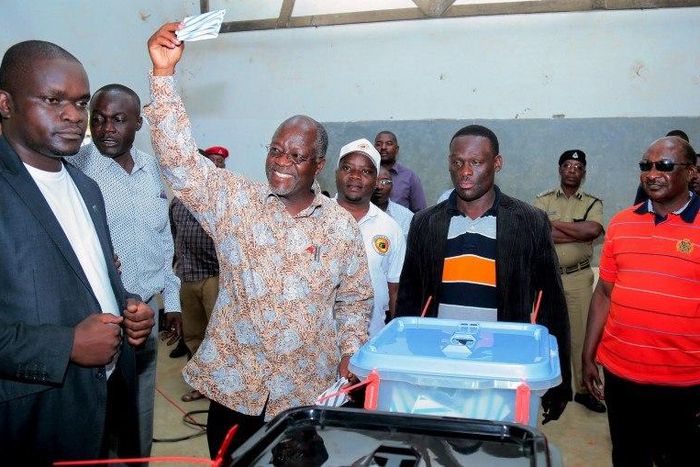 Tanzania's presidential candidate of the ruling Chama Cha Mapinduzi (CCM) party John Pombe Magufuli displays his ballot paper before casting his vote during the presidential and parliamentary election at his hometown Chato district, in Geita region, Oc...