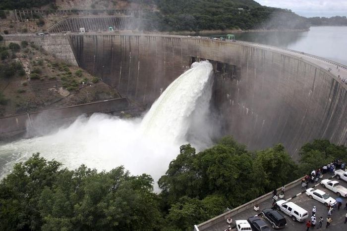 People watch as the spillway gates are opened at Kariba North Bank dam on Lake Kariba in a file photo. REUTERS/Mackson Wasamunu