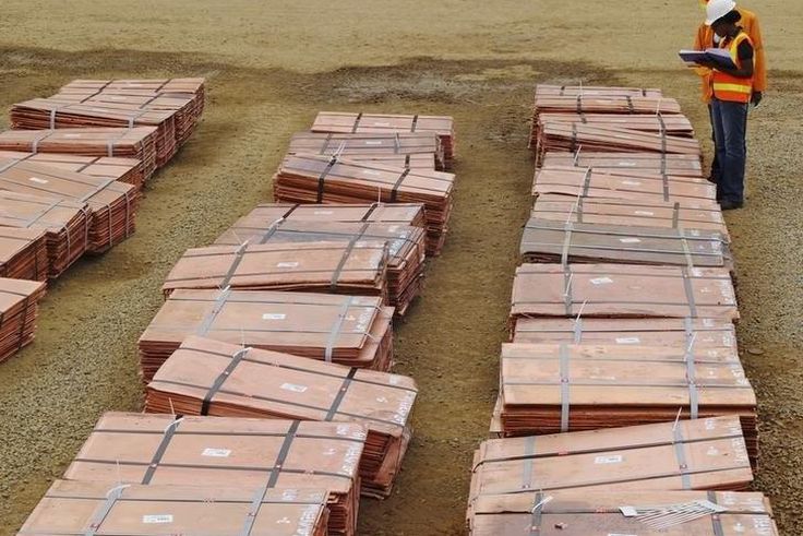 Workers at Tenke Fungurume, a copper mine in the southern Congolese province of Katanga, check bundles of copper cathode sheets ready to be loaded and sent out to buyers January 29, 2013. REUTERS/Jonny Hogg