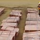 Workers at Tenke Fungurume, a copper mine in the southern Congolese province of Katanga, check bundles of copper cathode sheets ready to be loaded and sent out to buyers January 29, 2013. REUTERS/Jonny Hogg