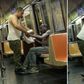 Man clothes shivering old black man on New York Subway