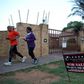 A couple jogs past a "for sale" sign outside a house in Johannesburg, February 1, 2016. REUTERS/Siphiwe Sibeko