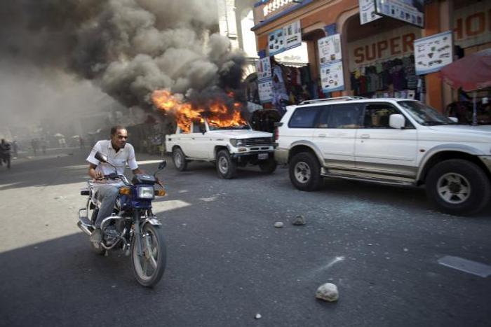 Protesters vow to derail Haiti presidential vote; election offices burned