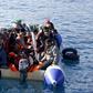 Refugees and migrants are seen on a dinghy as they approach the Ayios Efstratios Coast Guard vessel, during a rescue operation at open sea between the Turkish coast and the Greek island of Lesbos, February 8, 2016. REUTERS/Giorgos Moutafis