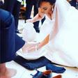 Bride washing her groom's feet