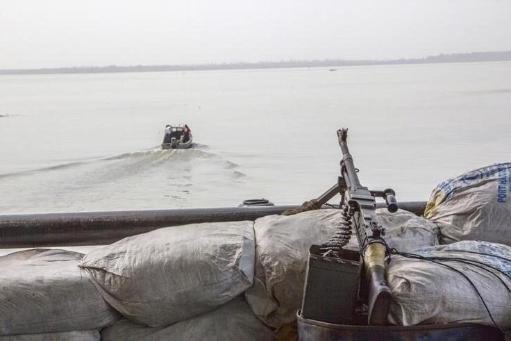 A machine gun is seen on a sandbag on a boat off the Atlantic coast in Nigeria's Bayelsa state December 19, 2013. REUTERS/Stringer