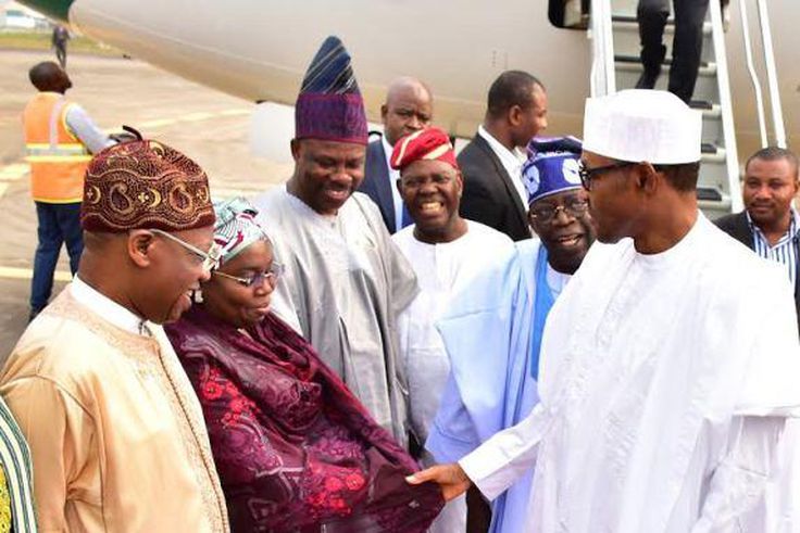 President Muhammadu Buhari in warm handshake with the Deputy Governor of Lagos State, Dr. (Mrs.) Idiat Oluranti Adebule at the Muritala Muhammed International Airport on Monday, February 1, 2016. They are flanked by: (L-R) Minister of Information and C...
