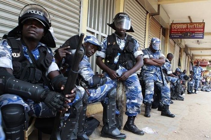 Riot policemen rest as they patrol a street in the Ugandan capital Kampala June 28, 2013. REUTERS/James Akena