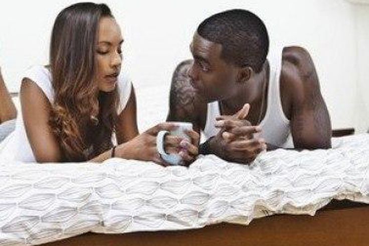 Couple talking in bed