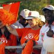 Ivory Coast"s President Alassane Ouattara of the Rally of the Houphouetists for Democracy and Peace (RHDP) party and his wife Dominique Ouattara wave during his last campaign rally, ahead of the October 25 presidential election, in Abidjan on October 2...