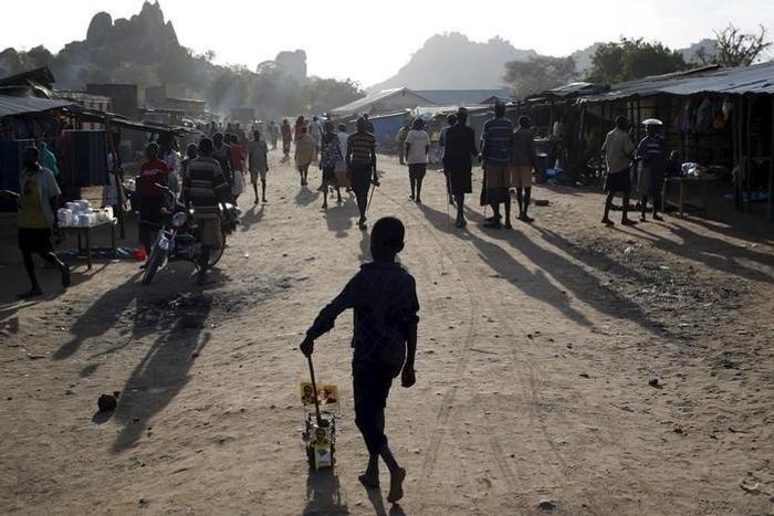 A Karamojong tribe boy plays with a toy decorated with election posters in town of Kaabong in Karamoja region, Uganda February 17, 2016. REUTERS/Goran Tomasevic