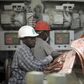 Labourers work at the Dangote Cement factory in Obajana village in Nigeria's central state of Kogi November 8, 2010. REUTERS/Akintunde Akinleye