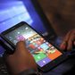 A Microsoft delegate checks applications on a smartphone during the launch of the Windows 10 operating system in Kenya's capital Nairobi, July 29, 2015. REUTERS/Thomas Mukoya