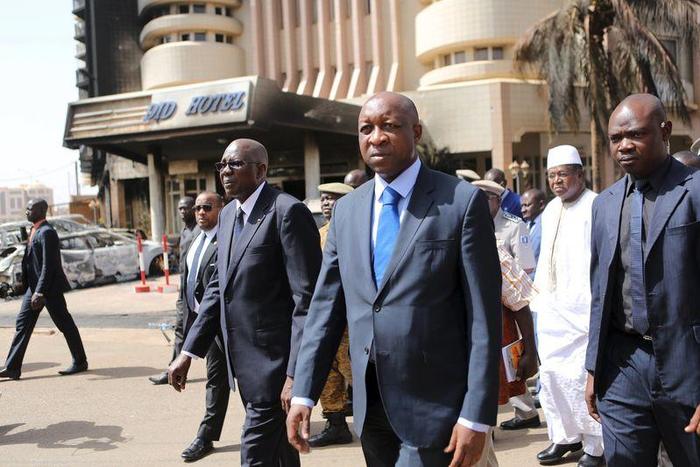 Mali's Prime Minister Modibo Keita (center L) and Burkinabe's Prime Minister Paul Kaba Thieba (center R) survey damage in front of the Splendid Hotel in Ouagadougou, Burkina Faso, January 17, 2016,. REUTERS/Joe Penney