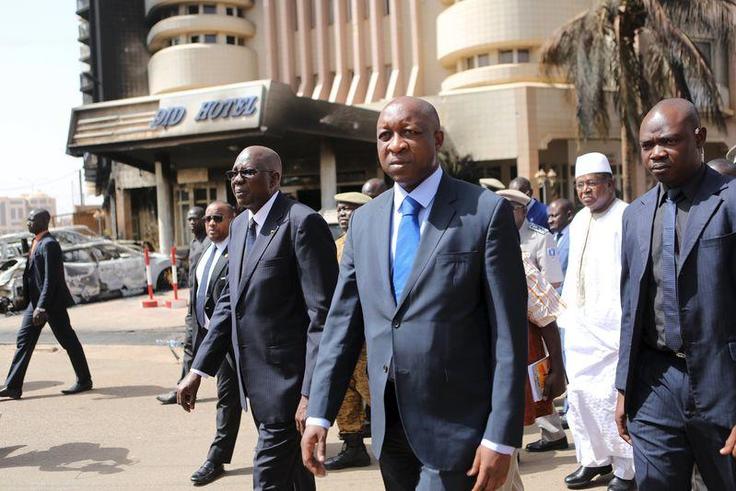Mali's Prime Minister Modibo Keita (center L) and Burkinabe's Prime Minister Paul Kaba Thieba (center R) survey damage in front of the Splendid Hotel in Ouagadougou, Burkina Faso, January 17, 2016,. REUTERS/Joe Penney