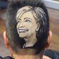 Maria Anita Monsivaiz shaves the face of Hillary Clinton on to her head