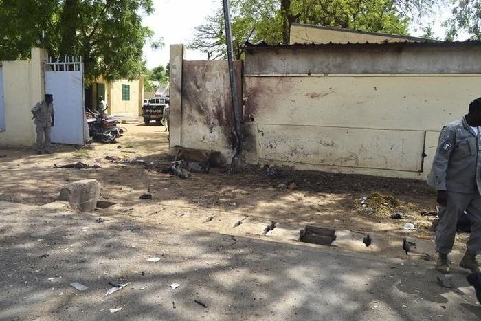 Security officers stand next to the site of a suicide bombing in Ndjamena, Chad, June 15, 2015. REUTERS/Moumine Ngarmbassa