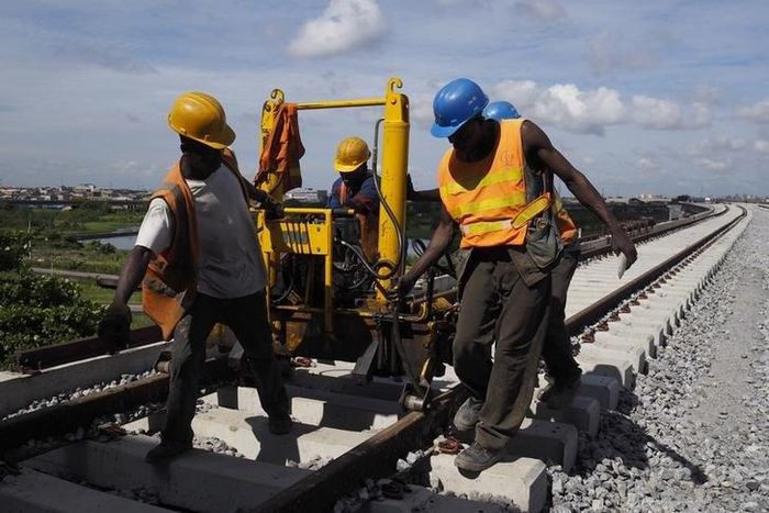 Men work on a train track at the National Arts Theatre stop of the light rail system under construction in Lagos, Nigeria, May 30, 2014.    REUTERS/Joe Penney